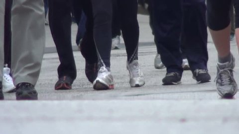 runners with sneakers around the city during the footrace