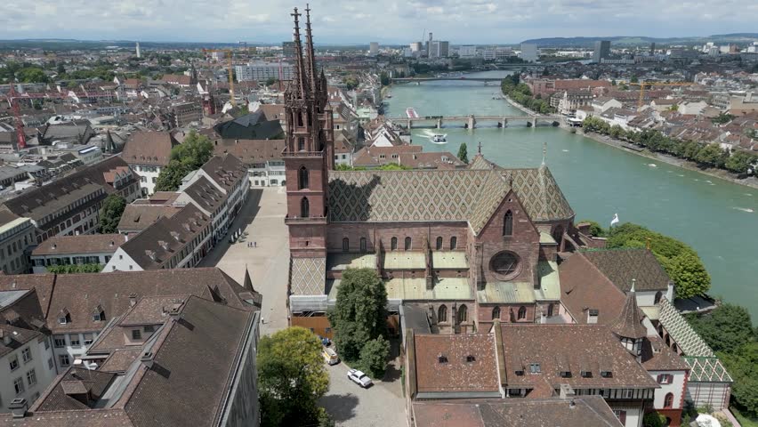 4K Drone Video of Historic Church with Twin Spires on the banks of the Rhine River in Downtown Basel, Switzerland (Track Left)
