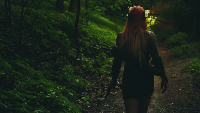 fantasy woman walking along path dark dense forest on beam of magical divine light at end of tunnel, fairy portal miracle. Fairy Girl elf hunter archer looks back, goes to exit silhouette rear view 4k