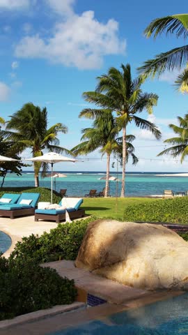 Luxury Tropical Resort Hotel, Vertical Drone Shot of Swimming Pool, Palm Trees and Sandy Beach