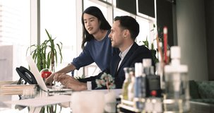 Middle-aged mentor explains corporate software, program or app to young Asian apprentice, listening explanation about joint task, or project during meeting in modern workspace. Mentorship, teamwork - Powered by Shutterstock - Get 15% off with code: PIKWIZARD15