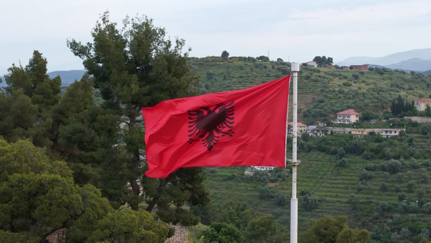 Flag of Albania with agricultural landscape background