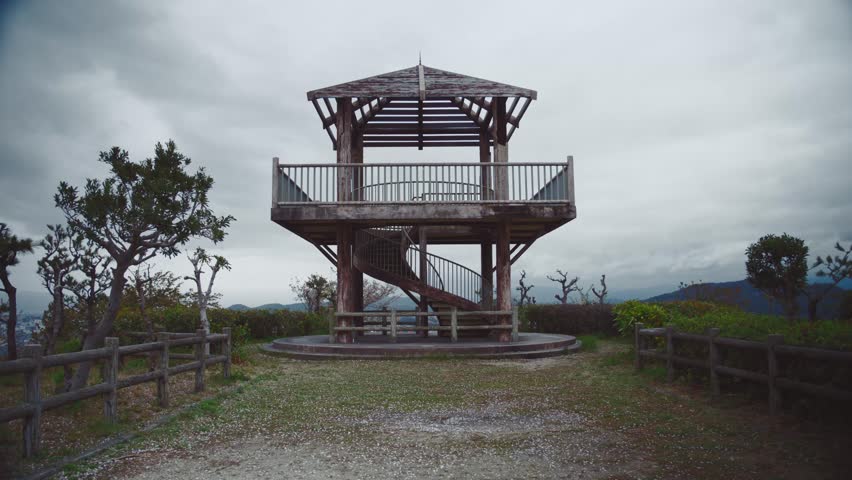 Wooden observation tower in Saikazaki, Japan on a cloudy day with scenic views of the surrounding landscape