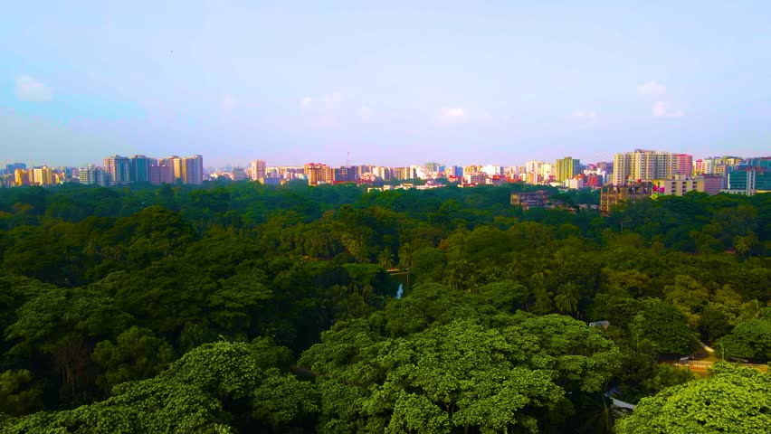Aerial view of the bustling cityscape of Dhaka, Bangladesh, with the serene greenery of Ramna Park creating a striking contrast.