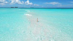 Woman chilling and walking on tropical white sand beach with turquoise ocean. Bikini woman on her vacation in Maldives - Powered by Shutterstock - Get 15% off with code: PIKWIZARD15