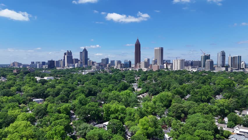 Drone shot pushing in on an Atlanta, Georgia skyline during the day.