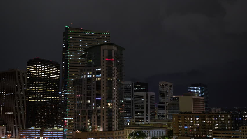 Lightning in night sky over city of Denver skyline and illuminated buildings
