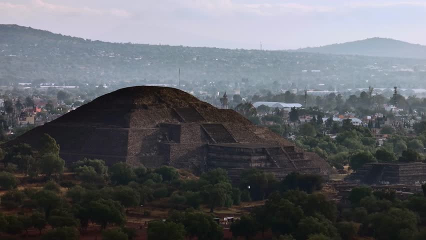 Morning light and shadows fall over the Pyramid of the Moon at Teotihuacan, Mexico. Pan left drone aerial