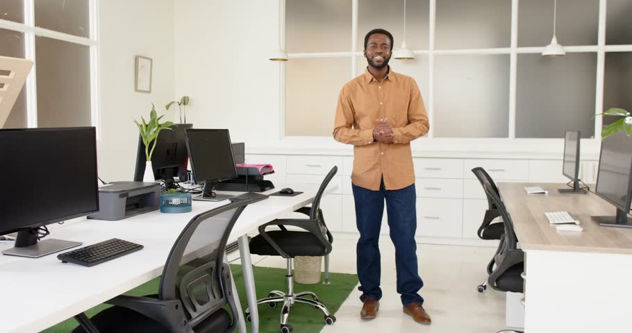 Close up of people talking to the camera, smiling man standing in modern office. the person is fully visible, standing, full body, talking to the camera with exaggerated hand movements