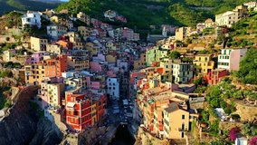 aerial view of Ligurian coast in Italy, Italian riviera of Cinque Terre aerial view, fishing village of Riomaggiore at sunset, holiday in Cinque Terre, Italy . High quality 4k footage - Powered by Shutterstock - Get 15% off with code: PIKWIZARD15