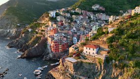 Drone view of Cinque terra coast in Italy, Italian riviera in Liguria aerial view, fishing village of Riomaggiore at sunset, holiday in Cinque Terre, Italy . High quality 4k footage - Powered by Shutterstock - Get 15% off with code: PIKWIZARD15