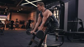 American Fit AthletIc Caucasian Man Doing Barbell Scott Bicep Curls Workout at Modern Gym. Sporty Male Building Biceps Brachii Muscle As Well As The Brachialis with Determination - full body shot - Powered by Shutterstock - Get 15% off with code: PIKWIZARD15
