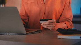 Senior woman entering credit card number on laptop, shopping online, discounts - Powered by Shutterstock - Get 15% off with code: PIKWIZARD15