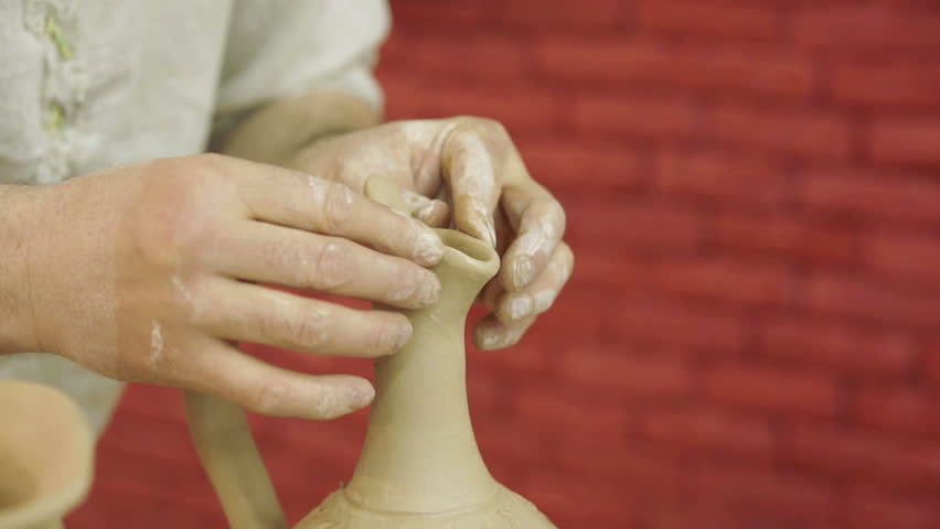 Potter works. Crockery creation process in pottery on potters' wheel