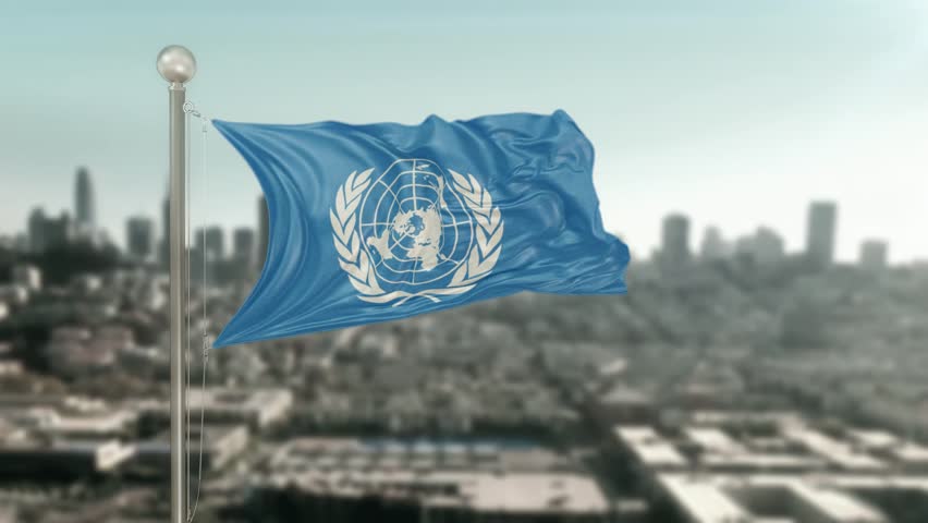United_Nations Pole Flag Against City Blurred Background 3D Rendering.