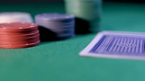 Close up of poker player checking cards, holding two aces. Slow panning motion - Powered by Shutterstock - Get 15% off with code: PIKWIZARD15