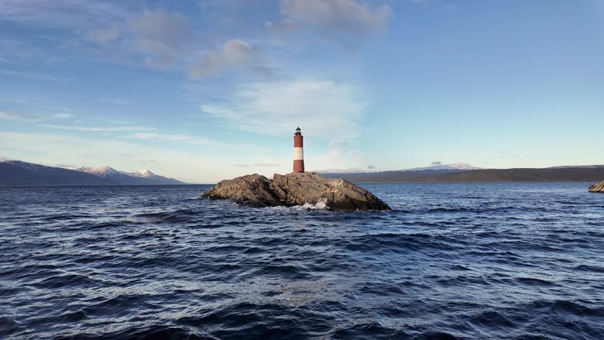 Ushuaia Lighthouse At Ushuaia In Tierra Del Fuego Argentina. Amazing Bay Water. Maritime Excursion. Boat Sailing Scene. Ushuaia Lighthouse At Ushuaia In Tierra Del Fuego Argentina.