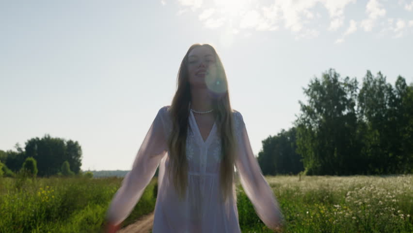 Woman running gracefully in a sunlit meadow