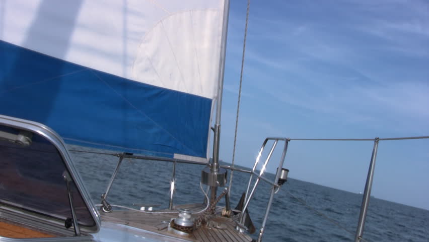 View of the nose a sailing yacht, which runs under sail on a background of calm
