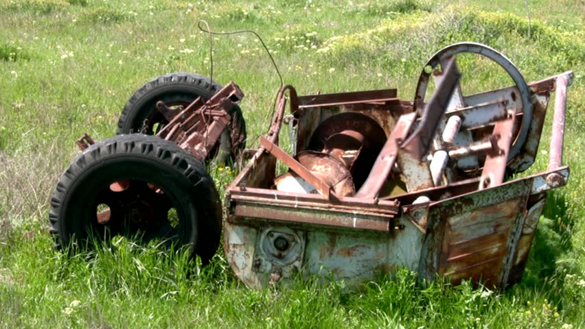 Rusty old mechanism is not clear destination is a long time in the steppe grass
