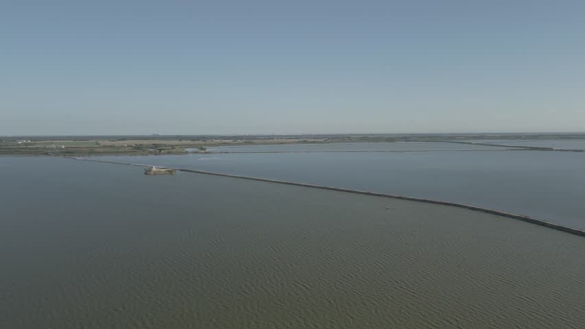 Camera pan over the Comacchio Valley revealing at the end the Argine degli Angeli that crosses the lagoon - 4k - 25 fps