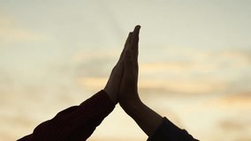 High five hands at sunset silhouette. Best friends buddies clapping each other palms in field park at dawn. Teamwork successfully completed business celebration rejoicing friendly feelings expression - Powered by Shutterstock - Get 15% off with code: PIKWIZARD15