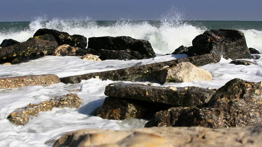 Sea waves hitting rocks on the coast