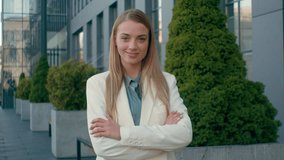 Confident smiling Caucasian woman blonde businesswoman employee student in formal suit looking at camera outdoors city downtown. Happy female hr manager crossing arms girl posing nod business success - Powered by Shutterstock - Get 15% off with code: PIKWIZARD15