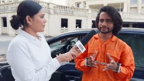 Reporter Interviews of Suspect, Female Journalist Interrogate Offender Man, Male prisoner in an orange prison suit, outside a jail building, The anchor hold microphone labeled news, Standing, Indian - Powered by Shutterstock - Get 15% off with code: PIKWIZARD15