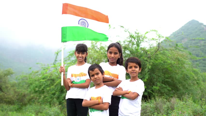 Group of happy Indian holding indian tricolour flag celebrating Independence day or Republic day.
