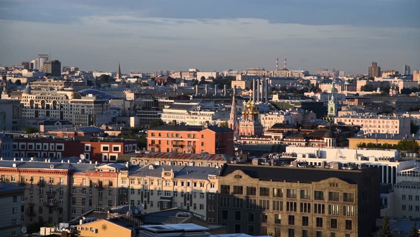 High angle panoramic cityscape of downtown district with residential, office and religious buildings at sunset in Moscow, Russia. Clouds on sky. Real time video. Capital cities theme.