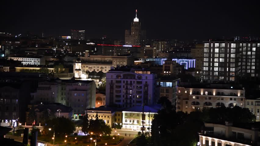 High angle panoramic cityscape of downtown district with residential, office and religious buildings at night in Moscow, Russia. Some street light illumination. Real time video. City life theme.