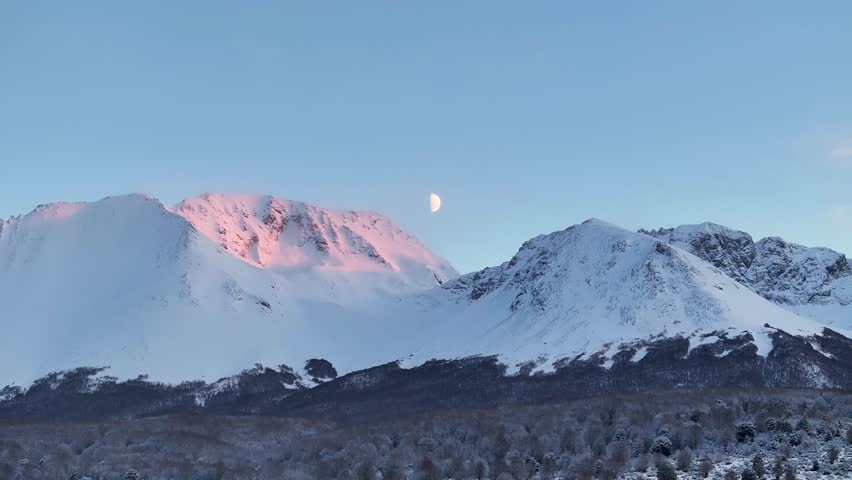 Scenic Moon At Ushuaia Tierra Del Fuego Argentina. Amazing Countryside Scenery Near Farm And Forest Trees. Sunset Illumination Glacial Landscape Blizzard. Snowing Day Mountain Frost.