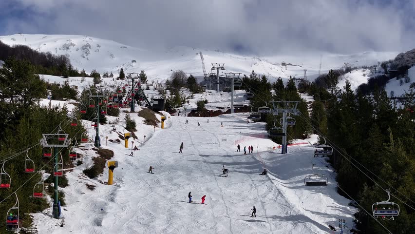 Cerro Catedral At Bariloche Rio Negro Argentina. Skier Skiing Downhill On Empty Ski Slopes In The Mountains. Nature Tourism Icon Snow Covered Forest Trees. Snow Covered Patagonia Aerial Landscape.