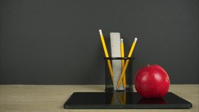 Back to school background with pencils, tablet and apple on it. Back to school or education concept. Stop motion - Powered by Shutterstock - Get 15% off with code: PIKWIZARD15