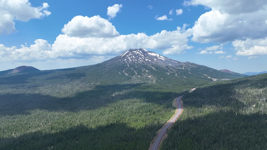 Forest surrounds Mount Bachelor, located not far from Bend, Oregon. Part of the cascade volcanic arc, this rugged mountain is a stratovolcano and is popular for biking, hiking, and skiing.