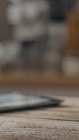 Portrait display. Restaurant establishment. Coffee master makes online payment by credit card at the bar, coffee specialist prepares and serves various drinks, new brewing technologies