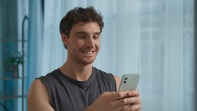 Caucasian European man sportsman trainer holding mobile phone smartphone texting online communication order delivery male guy athlete muscular strong smile technology chat physical connected energetic - Powered by Shutterstock - Get 15% off with code: PIKWIZARD15