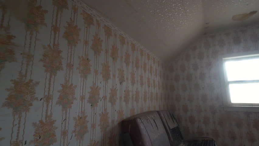 Aerial abandoned pioneer farm house bedrooms. Old pioneer home building. Walls, floors, ceiling and room deteriorating falling apart. Built in late 1800