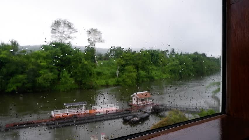 Rainy Day View From Window.The window is covered in raindrops.