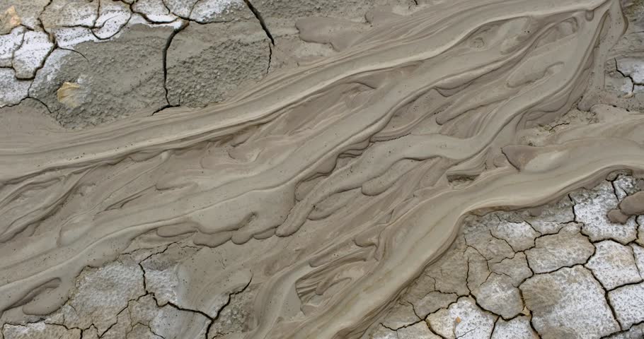 Muddy Vulcanos located in Buzau County, Romania, a National Landmark, Gas bubbles coming out a mud volcano. Paclele mici and Paclele Mari
