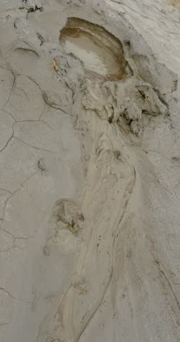 Muddy Vulcanos located in Buzau County, Romania, a National Landmark, Gas bubbles coming out a mud volcano. Paclele mici and Paclele Mari