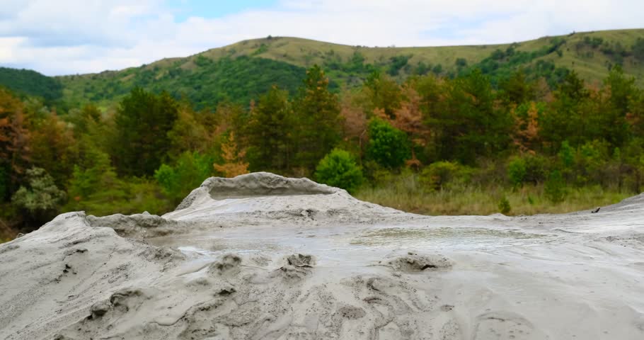 Muddy Vulcanos located in Buzau County, Romania, a National Landmark, Gas bubbles coming out a mud volcano. Paclele mici and Paclele Mari