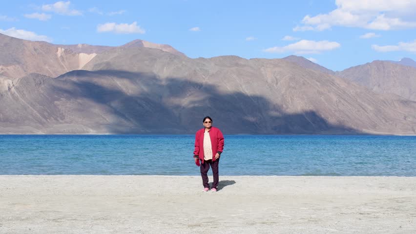 Couple is enjoying on Pangong lake of Ladakh