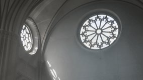 Low angle tilt down view of interior of lutheran church with arched vaults and round stained-glass windows - Powered by Shutterstock - Get 15% off with code: PIKWIZARD15