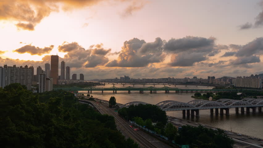 Beautiful Dramatic Sky Sunset Over Han River Overlooking Many Bridges, 63 Building and Car Traffic Time Lapse on Olympic Expressway, at Yeouido District in Seoul City, South Korea - wide static