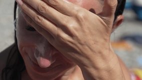 Woman Sunburn Protection Skin Care - Closeup of a woman's face while applying sunscreen to protect her skin from the sun. - Powered by Shutterstock - Get 15% off with code: PIKWIZARD15