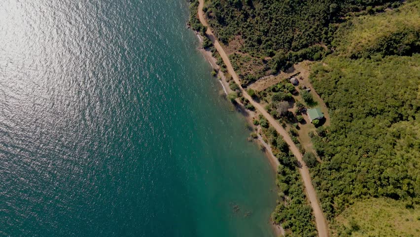 Drone shot of beautiful coastline, cristal blue water and green vegetation