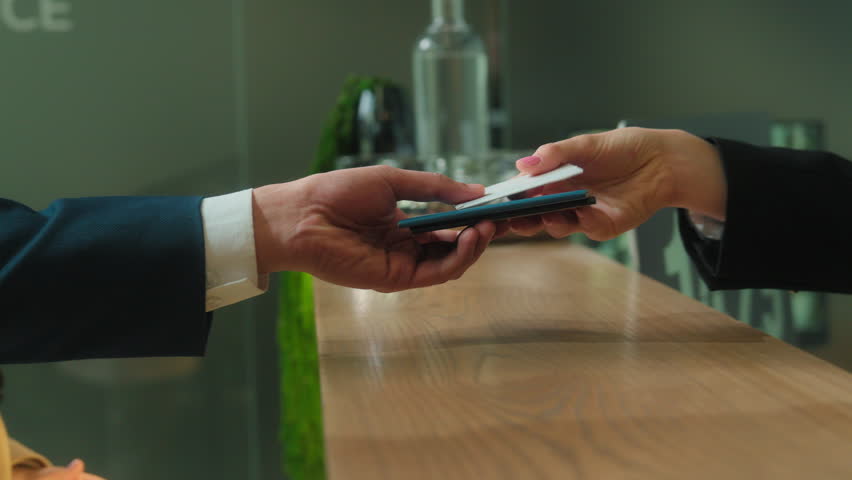 Close up hands give passports documents hotel reception couple man woman passengers tourists travelers booking room reserve apartment arrive resort travel trip tourism service concierge give key card
