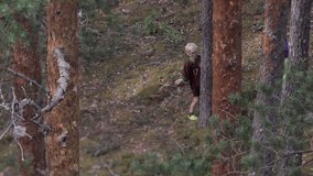 Two boys playing outside in a thick forest hit a tree with a tree branch. The scene captures a moment of childhood adventure and nature exploration. - Powered by Shutterstock - Get 15% off with code: PIKWIZARD15